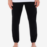 Black pants worn by a person on a white background
