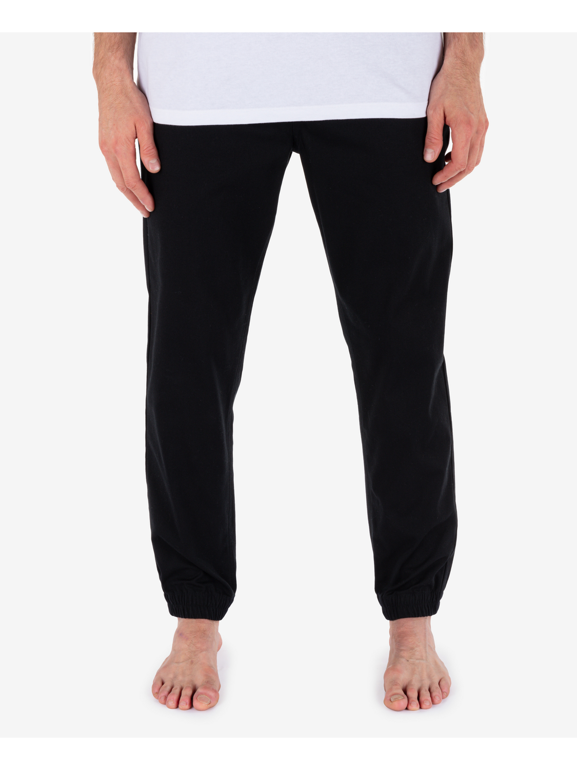 Black pants worn by a person on a white background