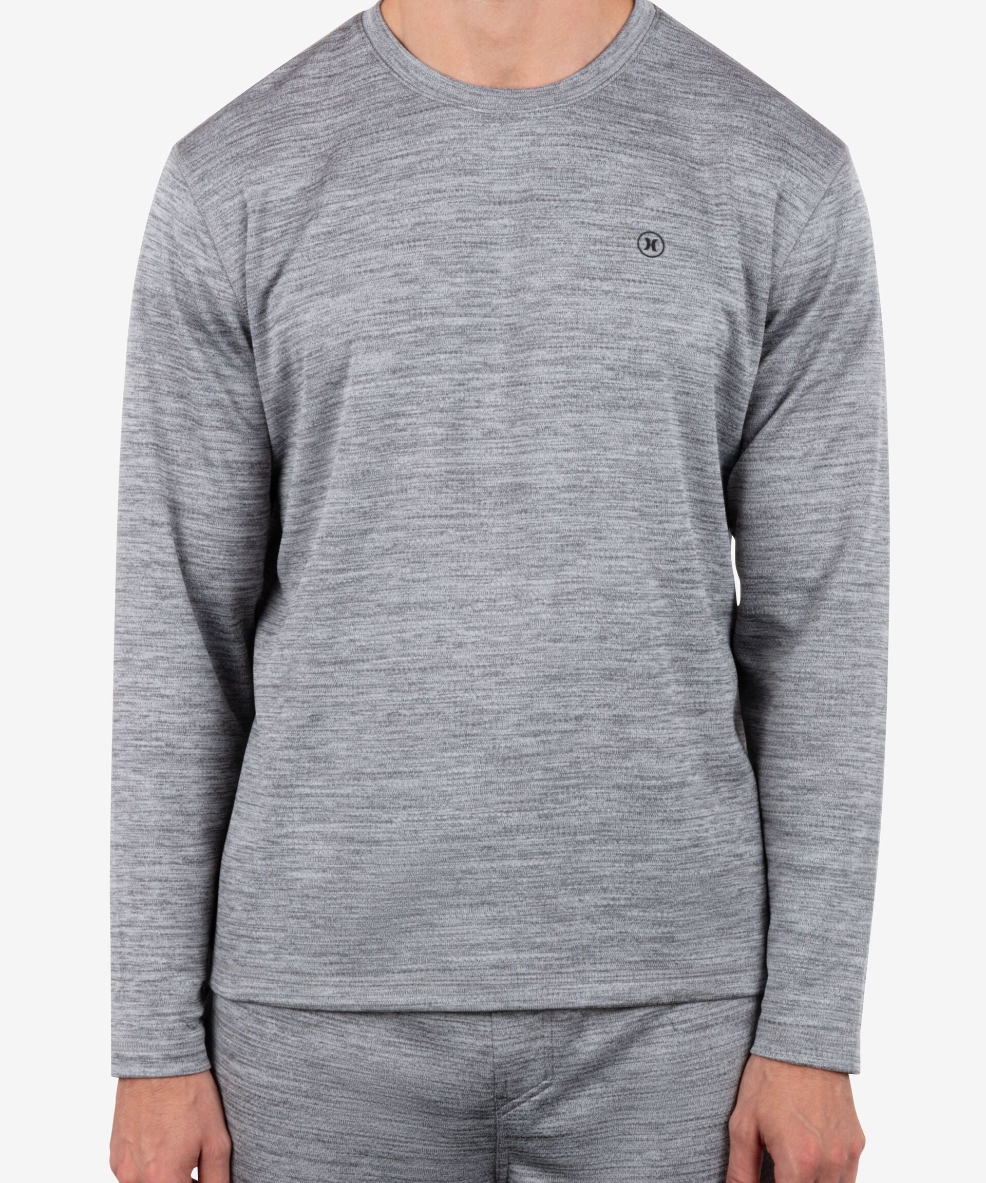 Person wearing a gray long-sleeve shirt and pants on a white background