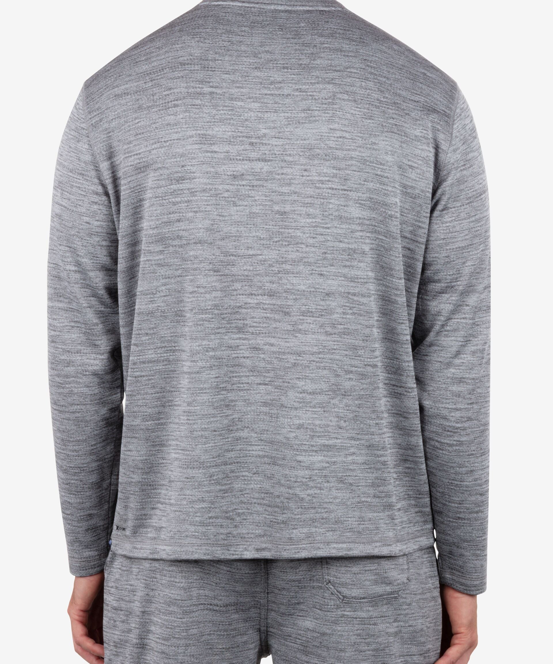 Person wearing a gray long-sleeve shirt and pants on a white background