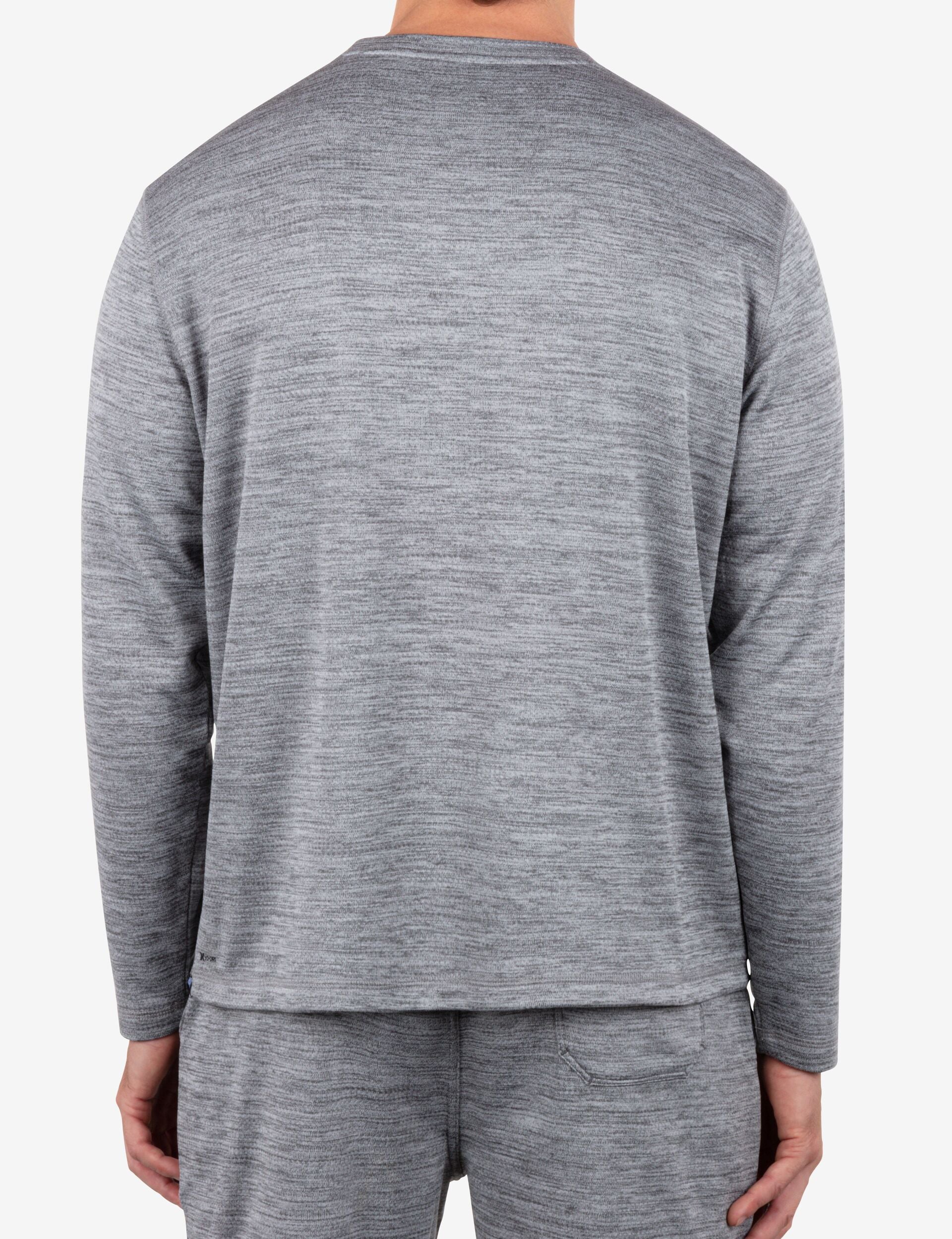 Person wearing a gray long-sleeve shirt and pants on a white background