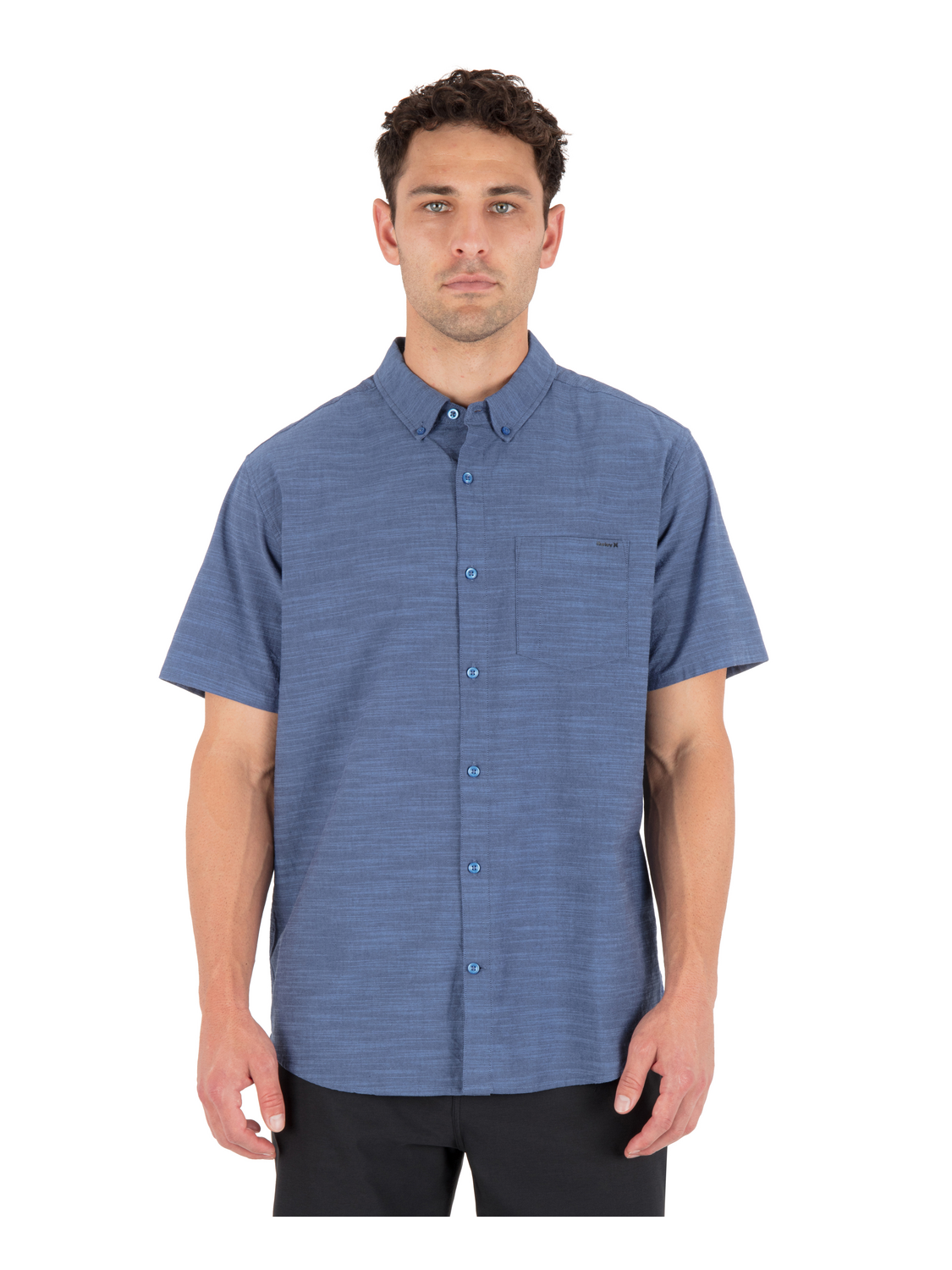 Man wearing a blue short-sleeve shirt on a white background