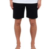 Person wearing black shorts and a white shirt on a white background