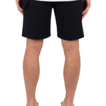 Person wearing black shorts on a white background
