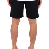 Person wearing black shorts on a white background