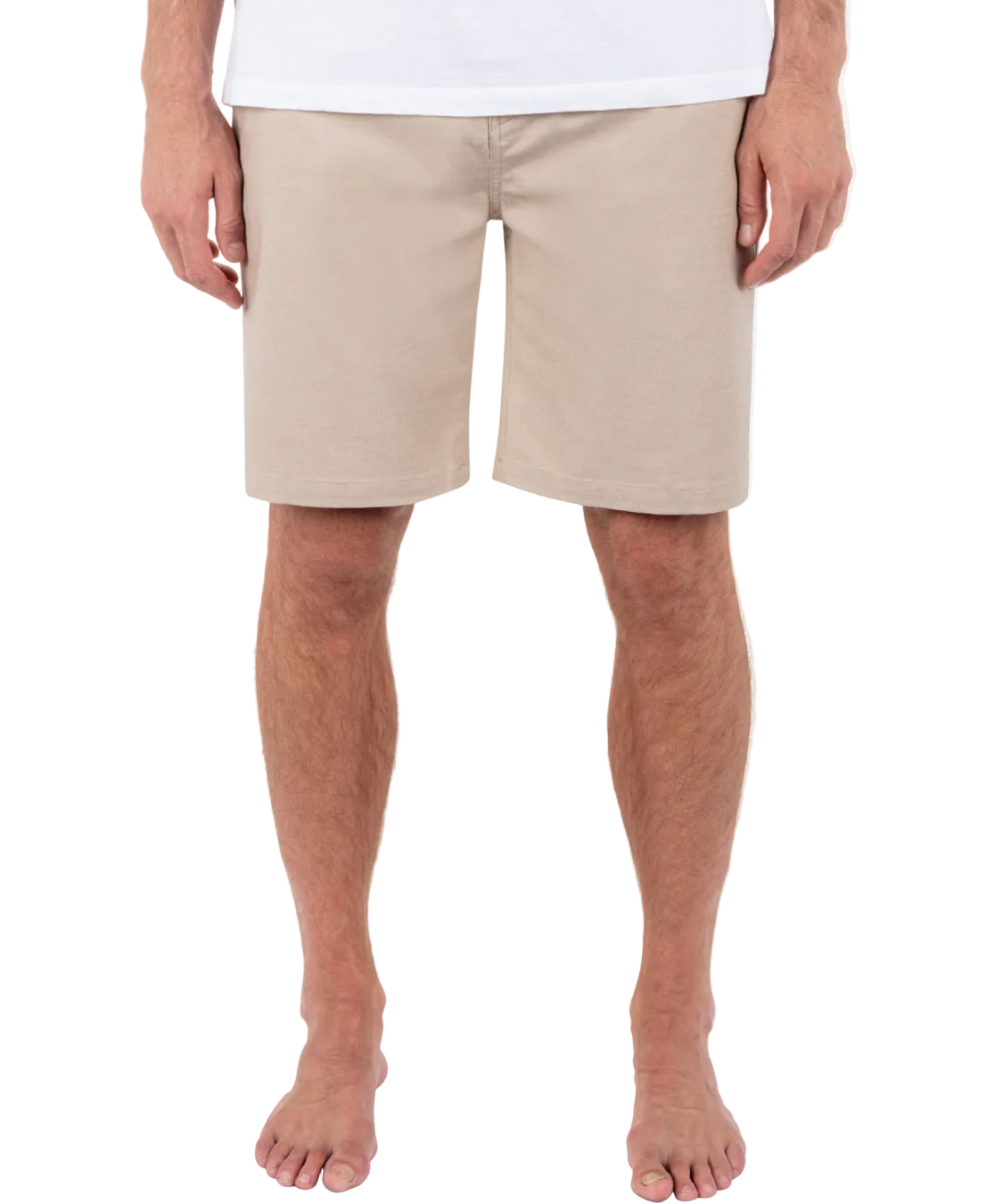 Person wearing beige shorts on a white background