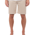 Person wearing beige shorts on a white background