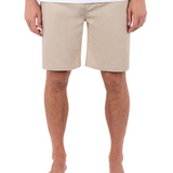Person wearing beige shorts on a white background
