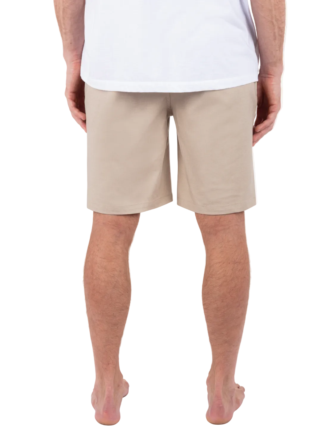 Person wearing beige shorts and a white shirt on a white background