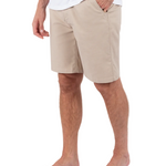 Person wearing beige shorts on a white background