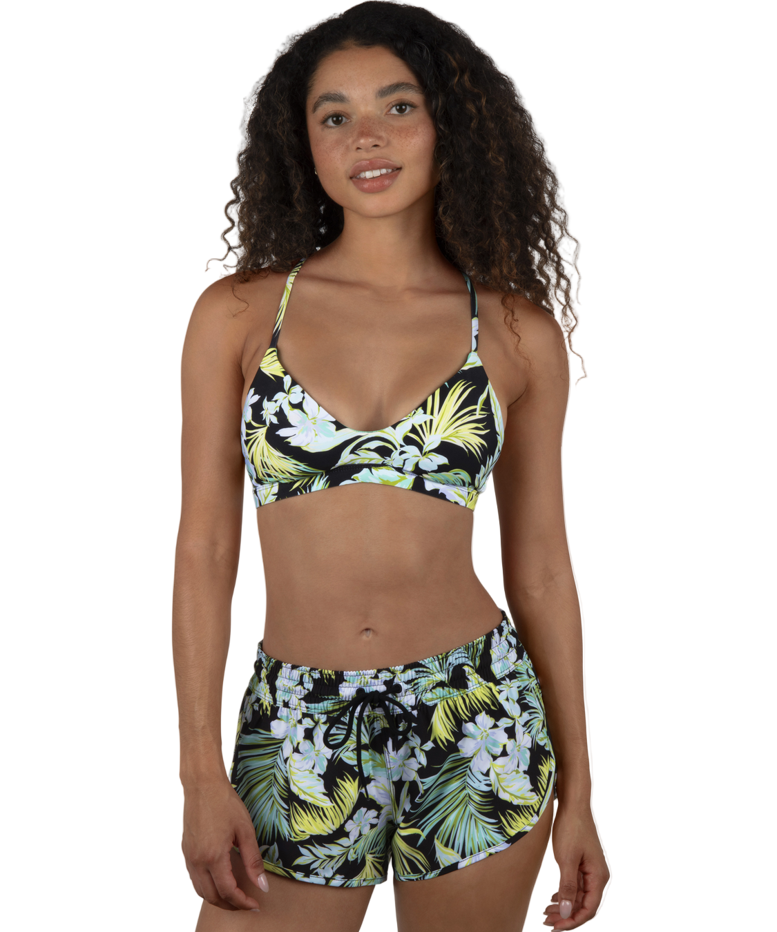 Woman wearing a tropical print bikini set on a white background