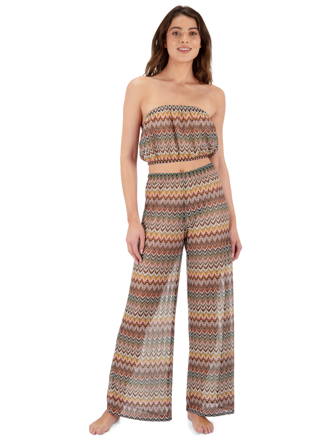 Woman wearing a strapless, multicolored zigzag patterned top and pants on a white background