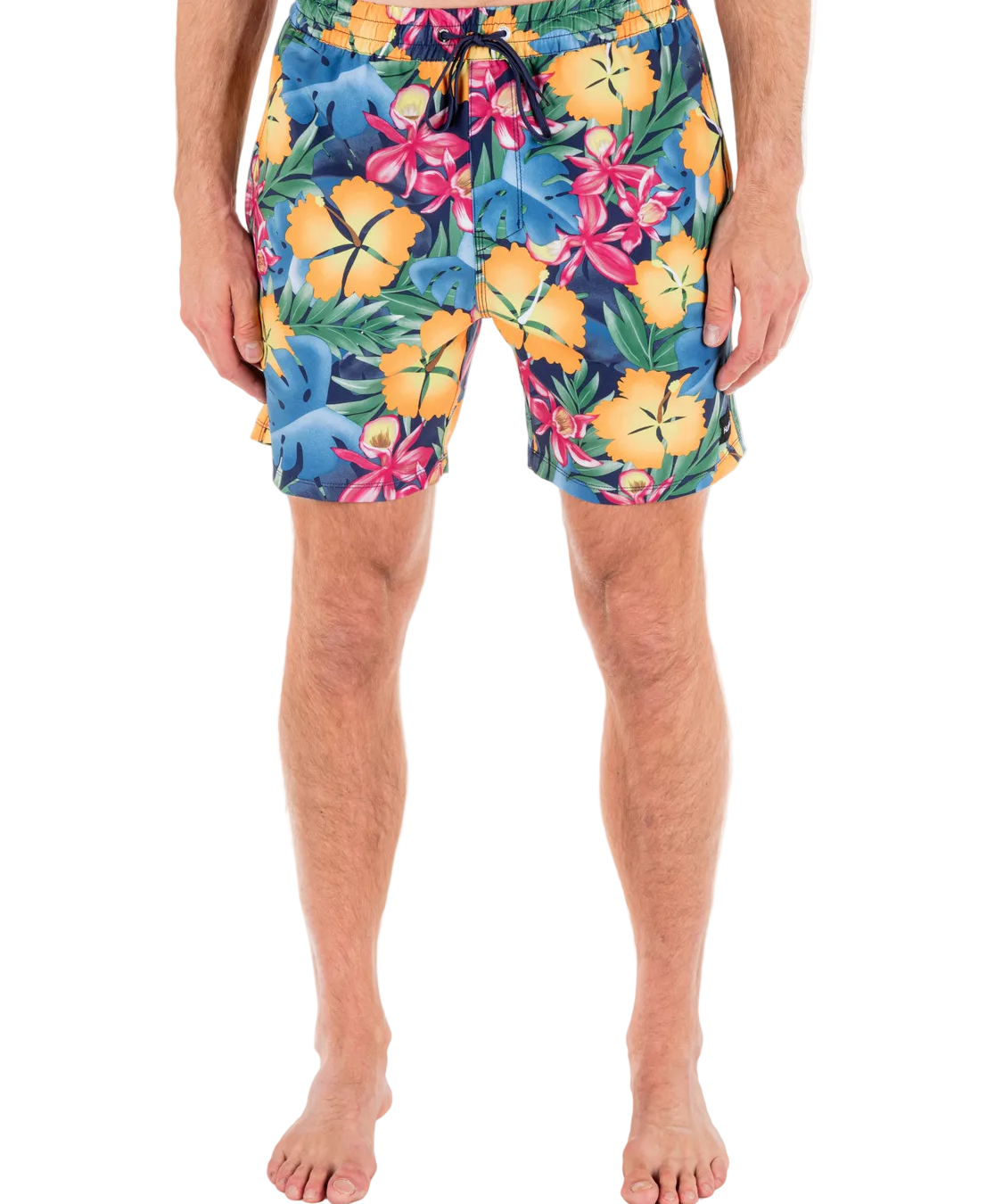 Person wearing colorful floral swim shorts on a white background