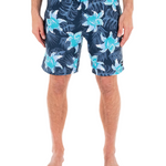 Person wearing navy shorts with blue floral patterns on a white background