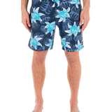 Person wearing navy shorts with blue floral patterns on a white background