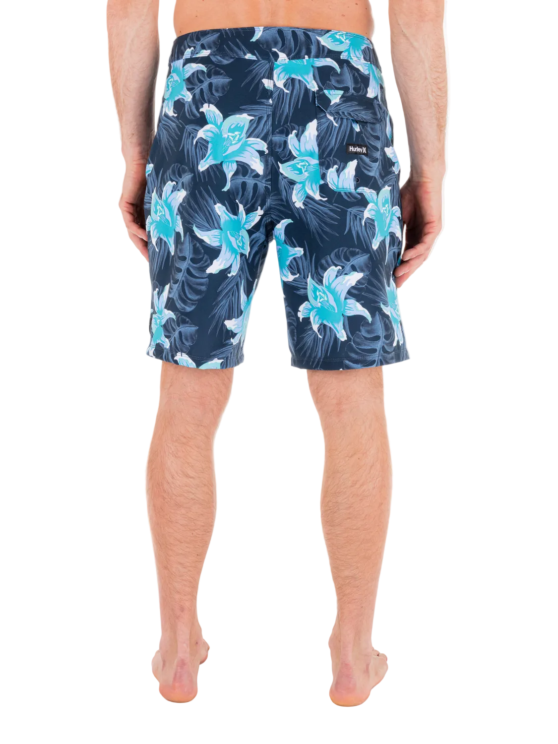 Person wearing blue floral swim shorts on a white background