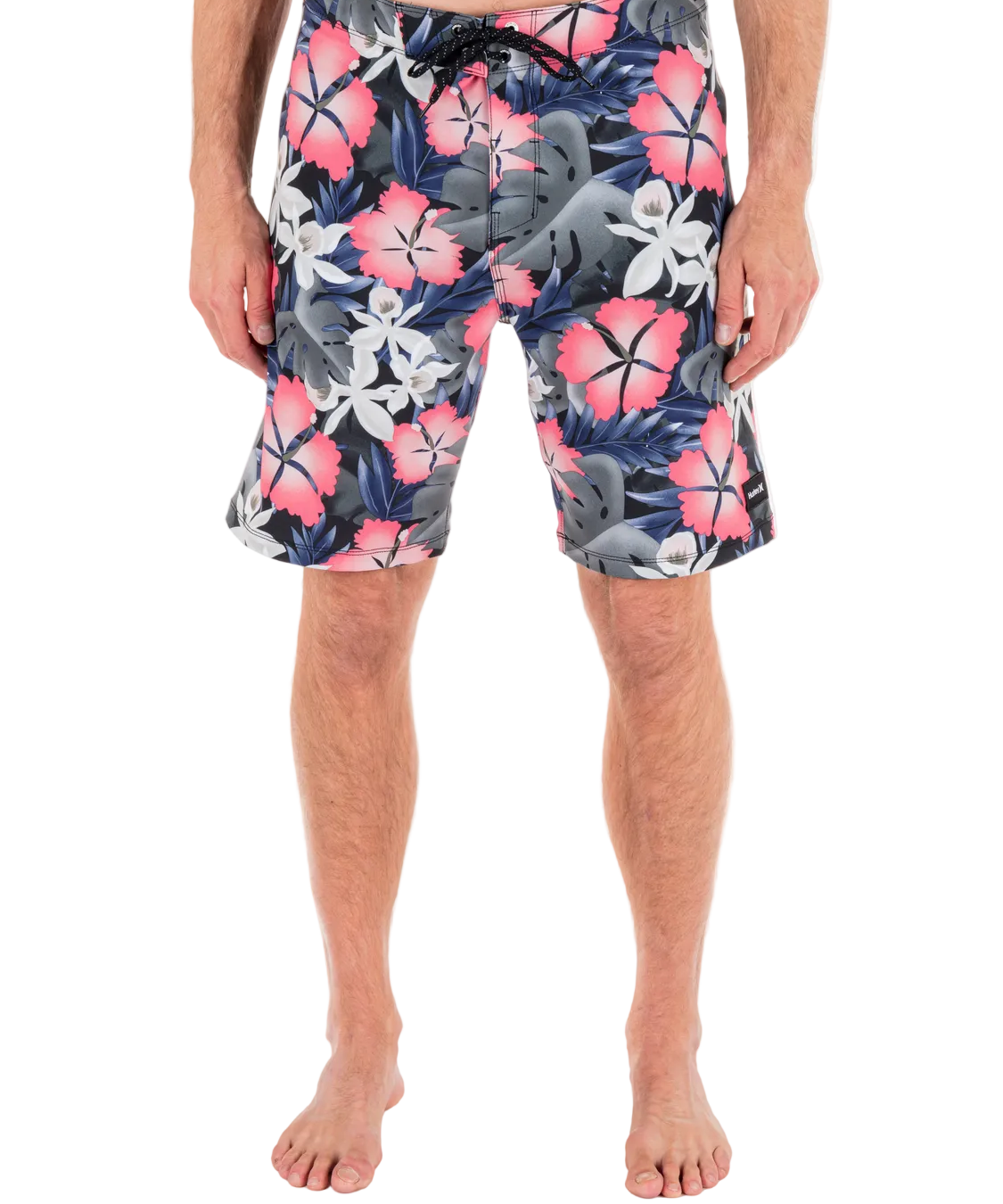 Person wearing colorful floral swim shorts on a white background