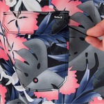 Close-up of a floral-patterned shirt with a graphic and Hurley logo.