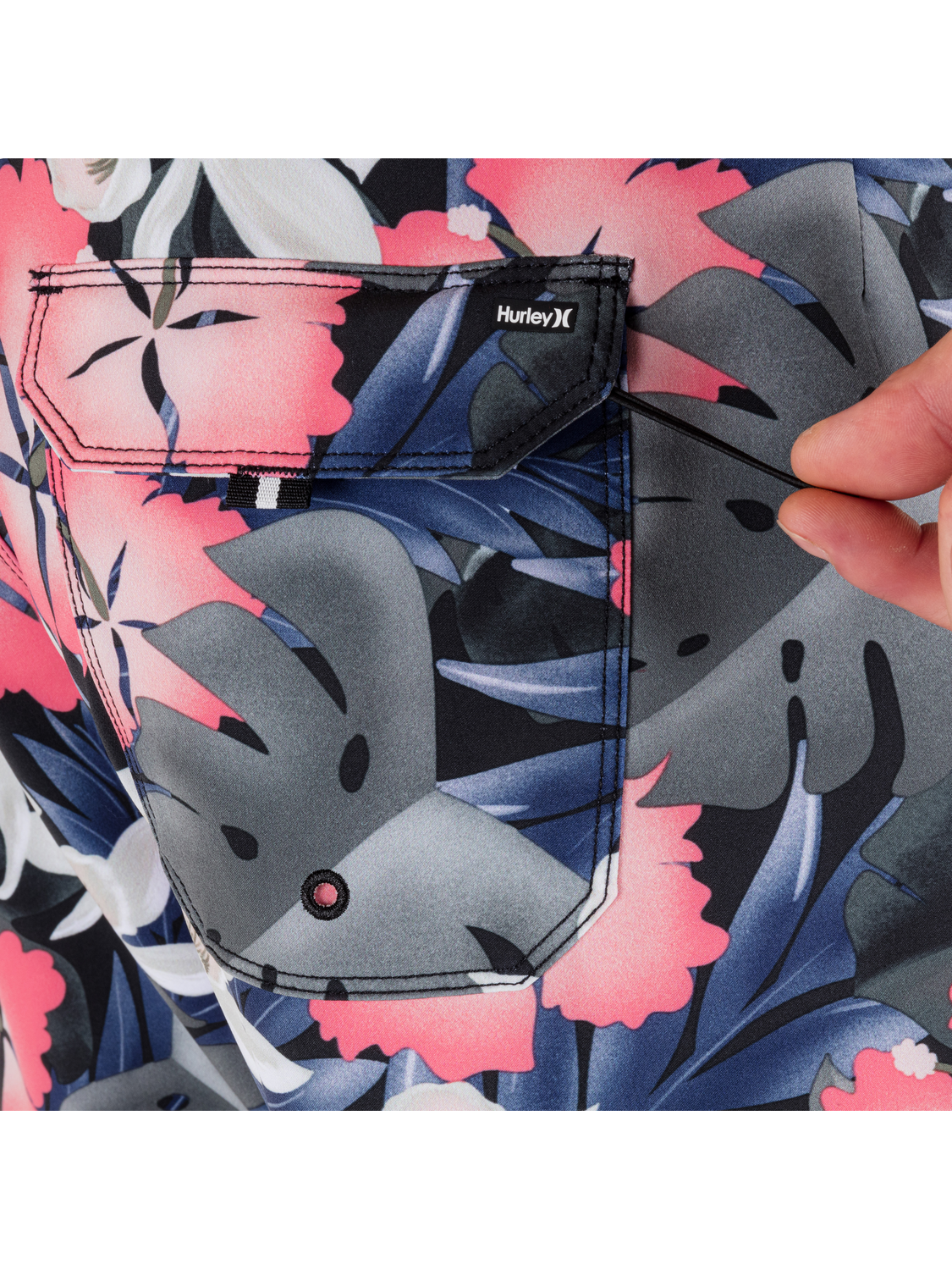 Close-up of a floral-patterned shirt with a graphic and Hurley logo.