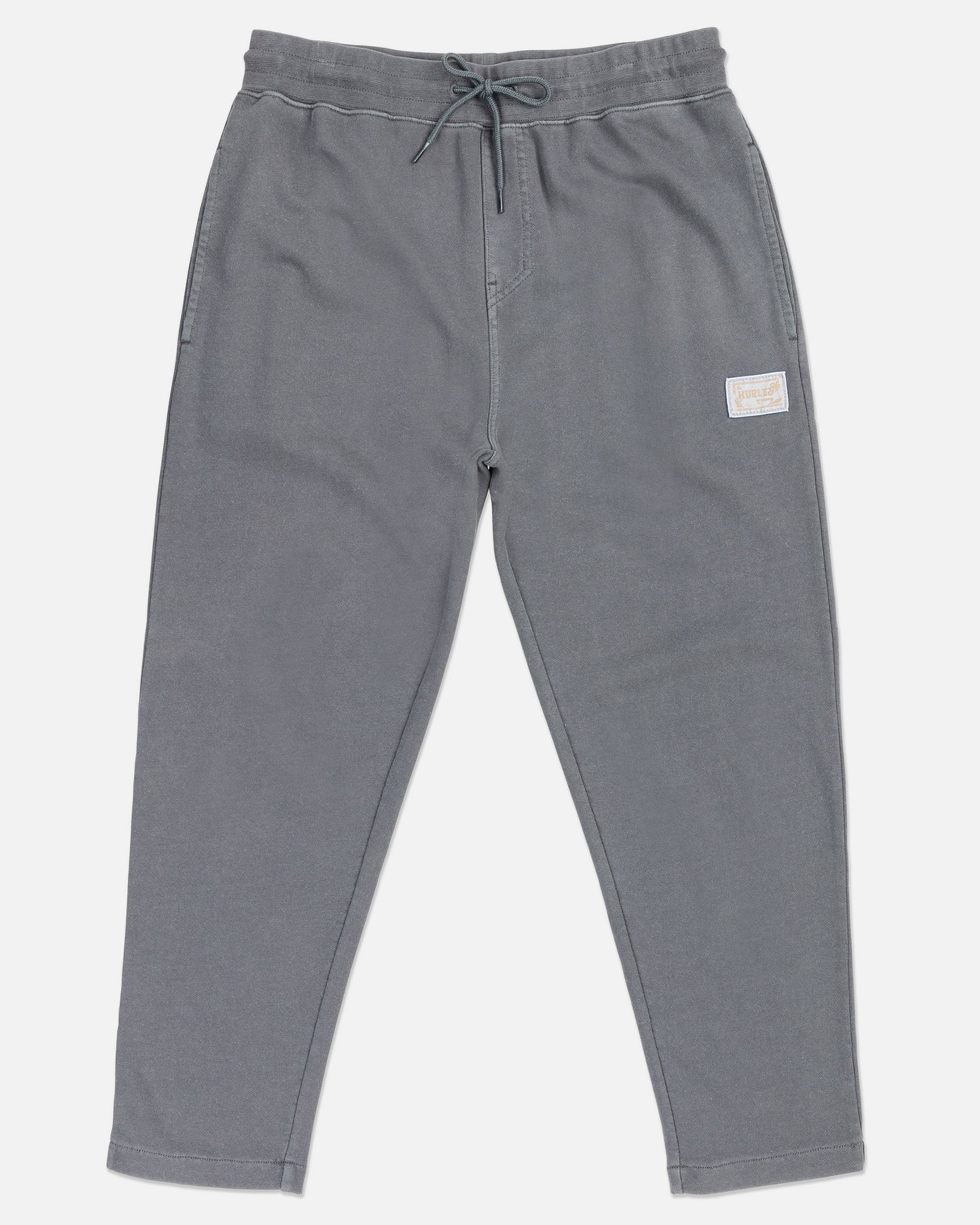 A pair of gray joggers with elastic waistband and straight hem, featuring side pockets and a small brand patch on the left leg.