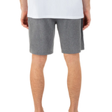 Person wearing gray shorts on a white background
