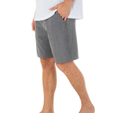 Person wearing gray shorts and a white shirt on a white background