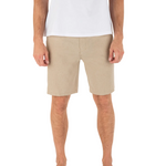 Person wearing beige shorts and a white shirt on a white background