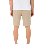 Person wearing beige shorts and a white shirt on a white background