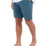 Person wearing blue shorts on a white background