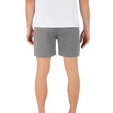 Person wearing gray shorts and a white shirt on a white background