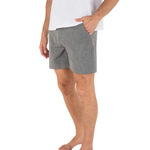 Person wearing gray shorts and a white shirt on a white background