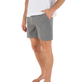 Person wearing gray shorts and a white shirt on a white background