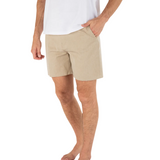 Person wearing beige shorts and a white shirt on a white background