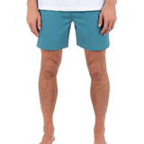 Person wearing teal shorts on a white background