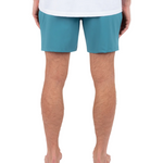Person wearing teal shorts on a white background