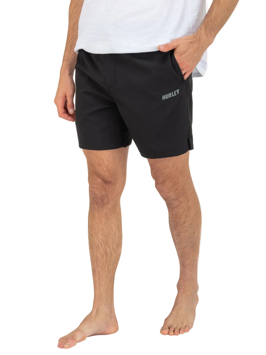 Person wearing black Hurley shorts on a white background