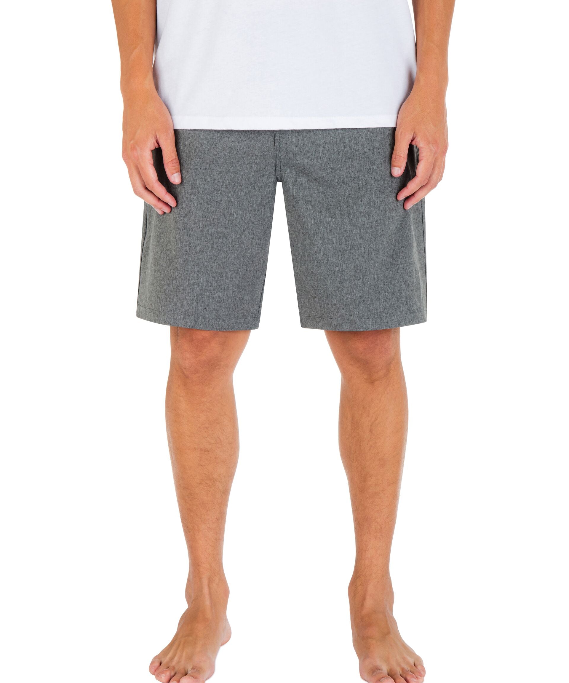Person wearing gray shorts on a white background