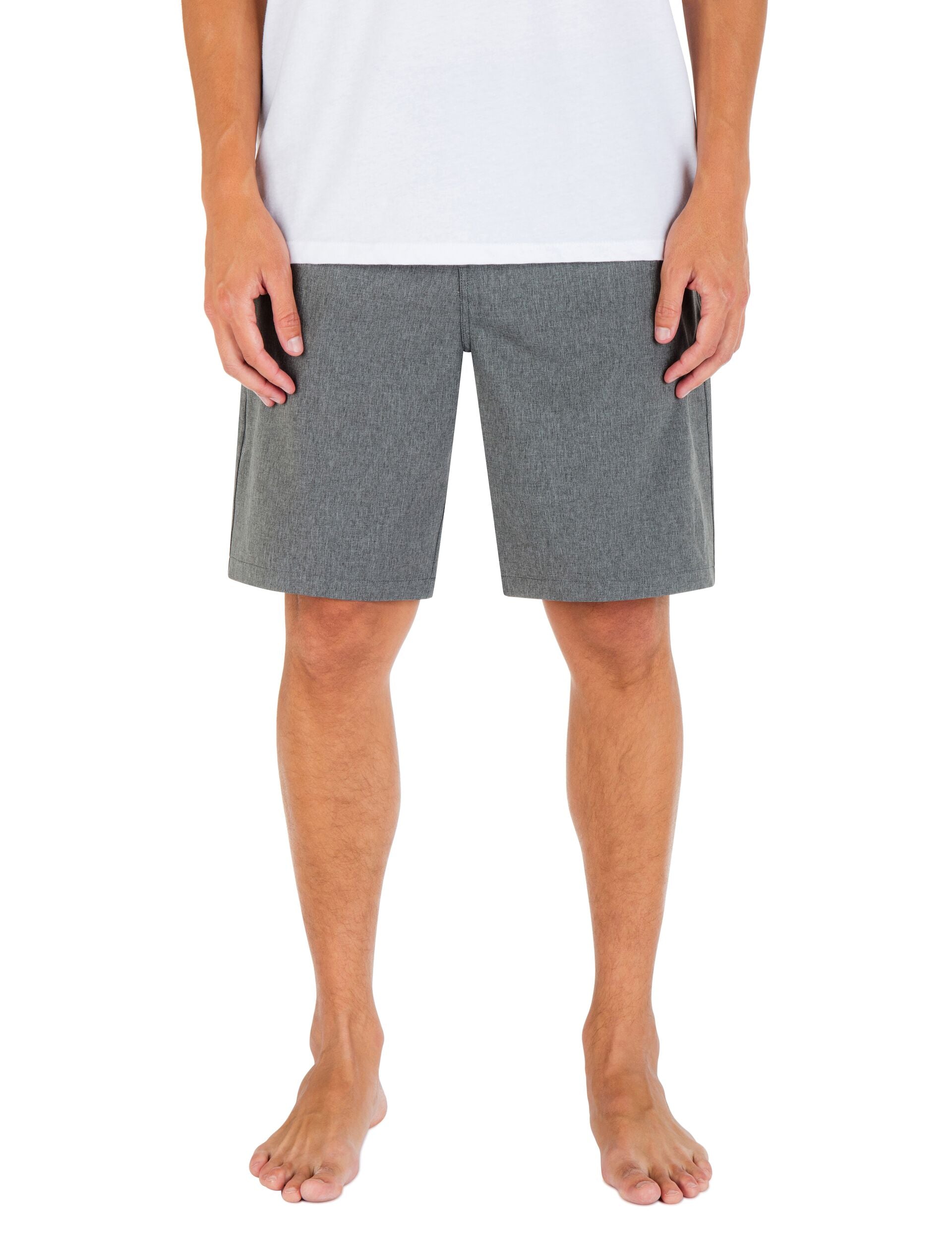 Person wearing gray shorts on a white background